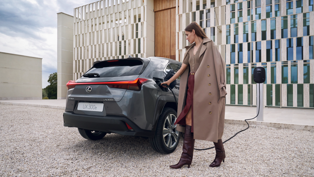 A person plugging in a charging socket into a Lexus UX 300e